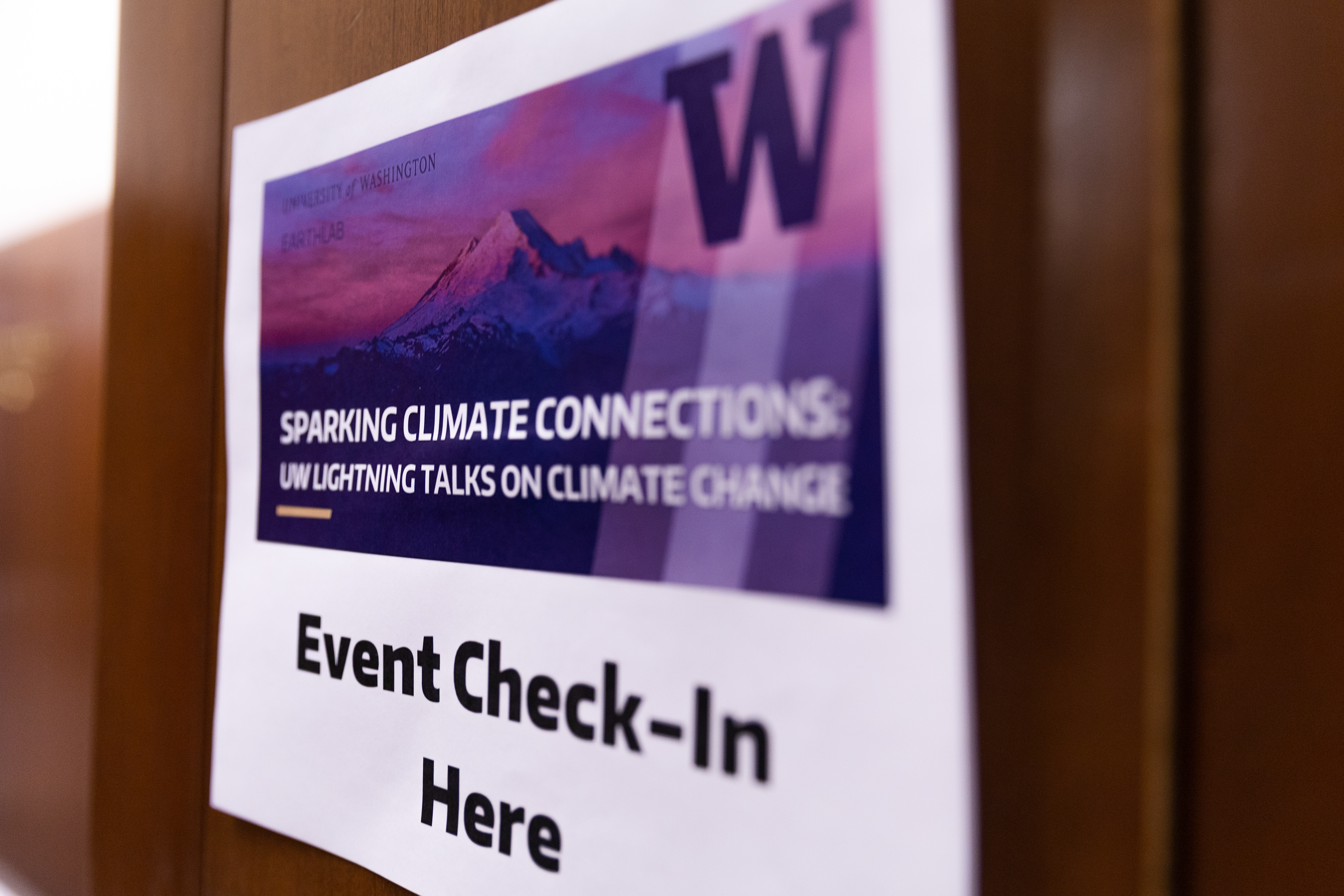 Event check-in sign: Sparking Climate Connections, UW Lightning Talks on Climate Change