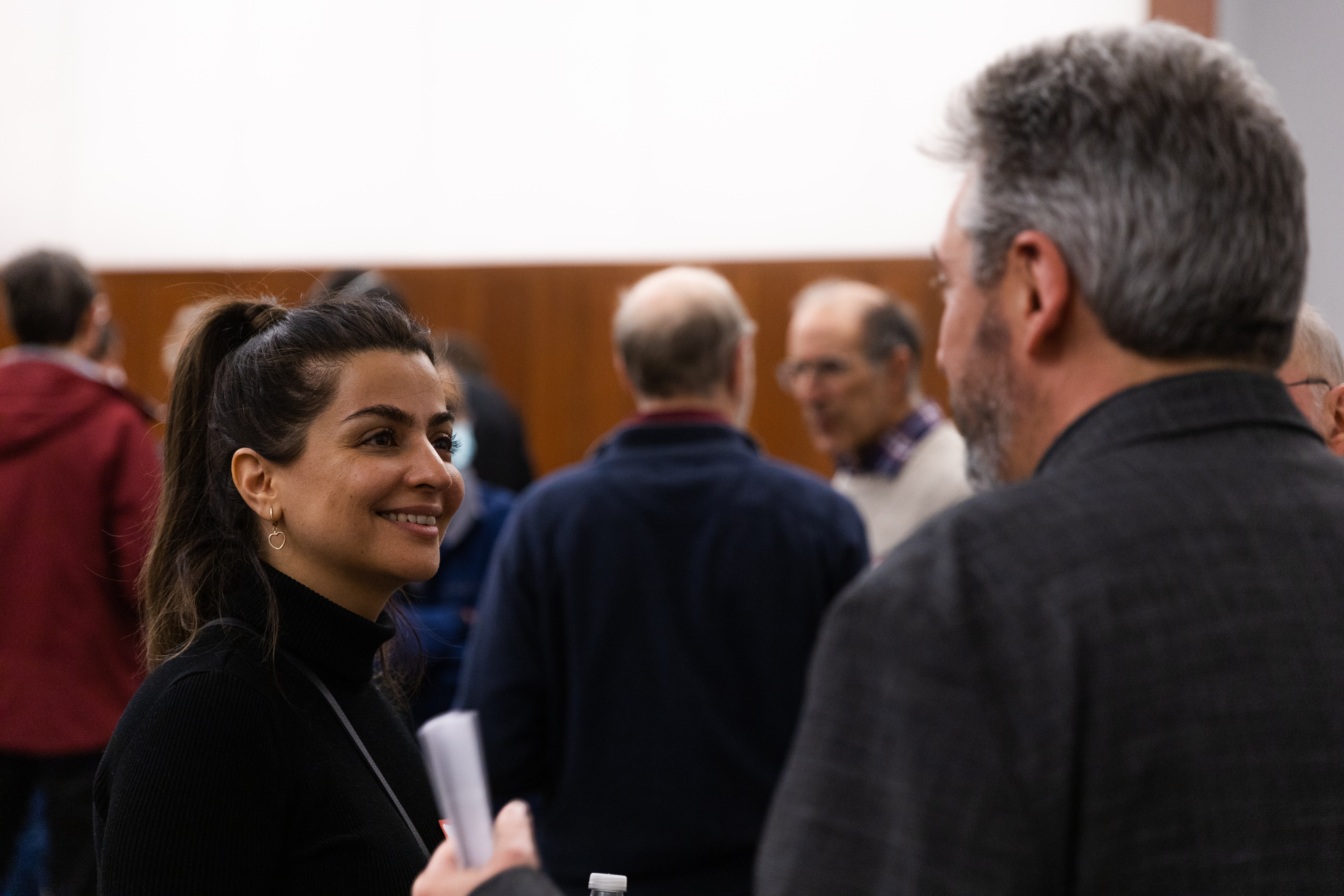 Attendee in conversation during the post-talk reception